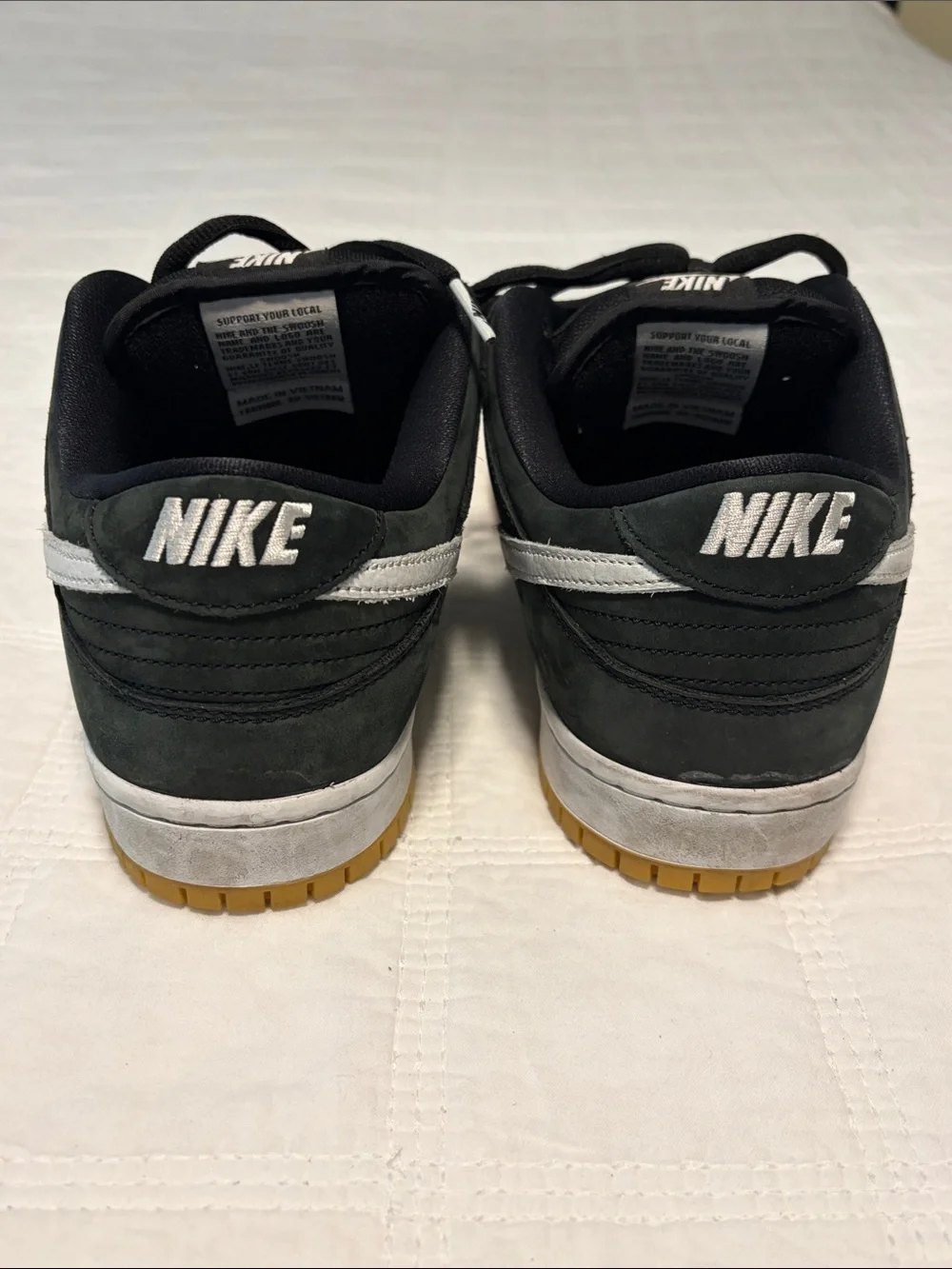 Nike Black Low-Top Sneakers with White Swoosh and Gum Sole
